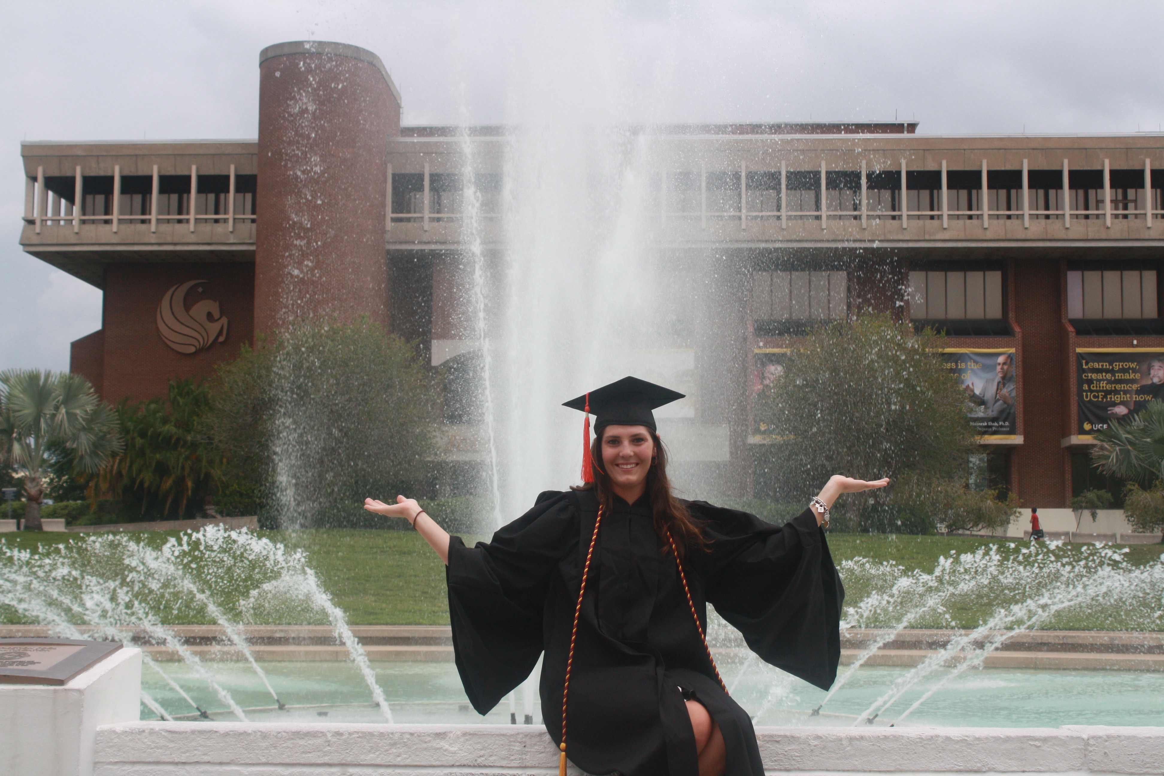 Graduate in front of UCF Reflecting Pond