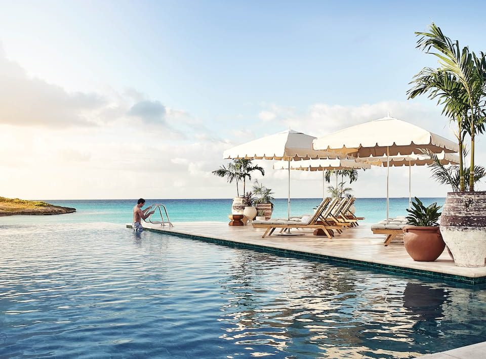 Belmond Cap Juluca's infinity pool and shaded lounge seating