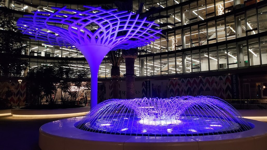 Santana Row Plaza Fountain lit up at night with purple underwater LED lights