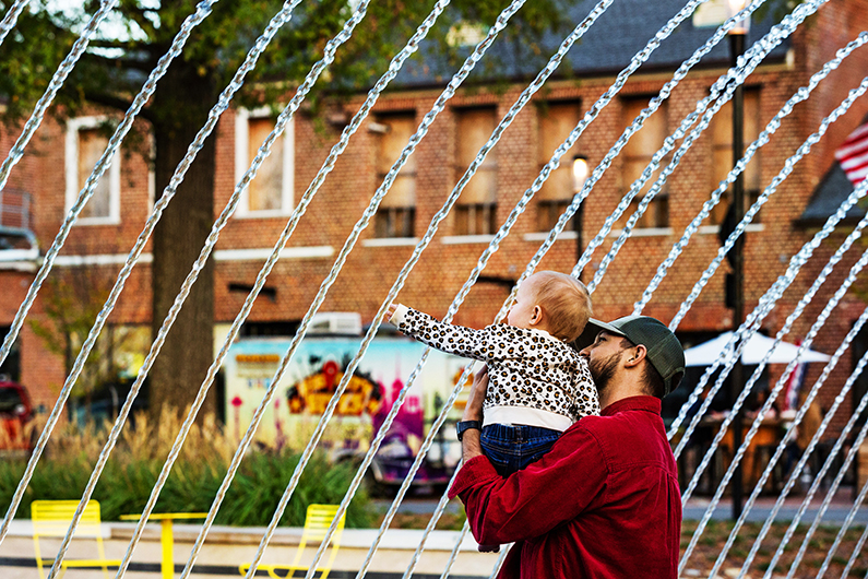 Family interacting with Kannapolis Downtown's nozzle arcs