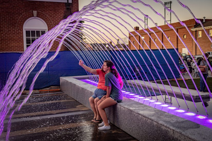 Kannapolis Downtown invites people to sit inside curved fountain sprays