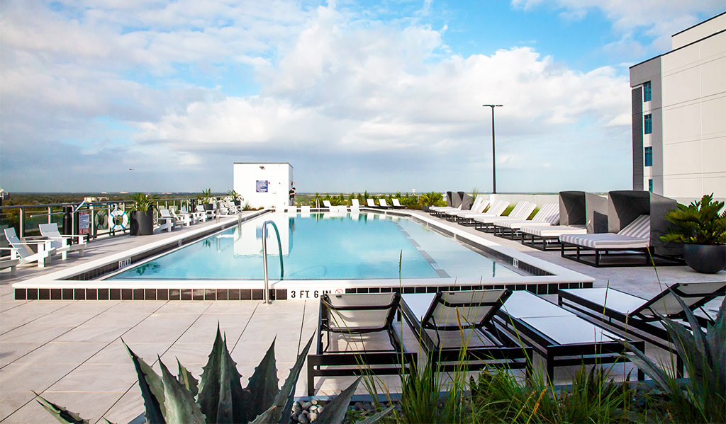 Lounge chairs at The Julian Orlando rooftop pool