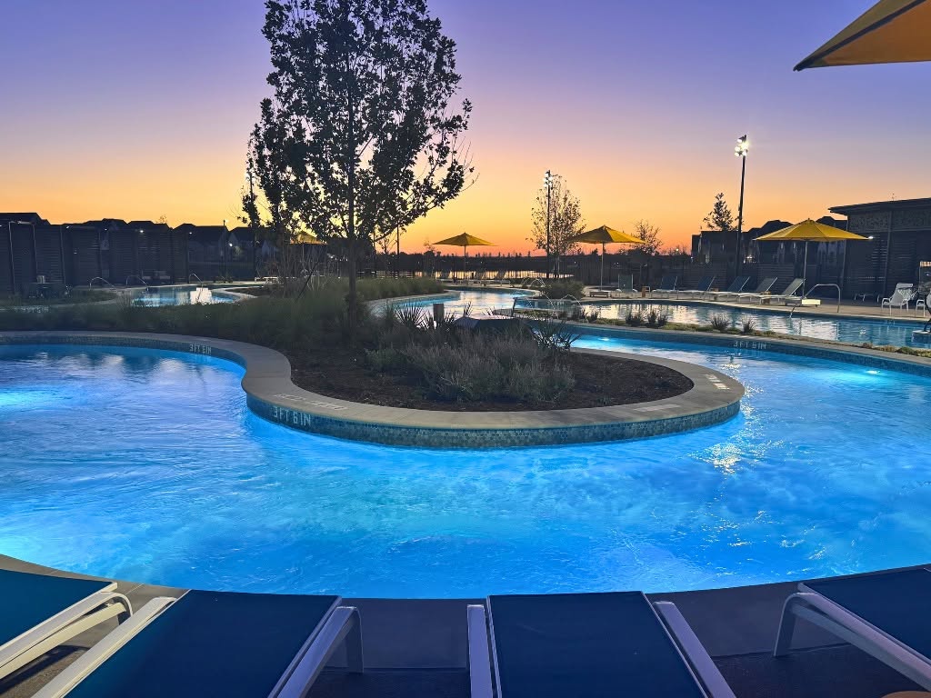 Nighttime view of the Mosaic Amenity Center lazy river