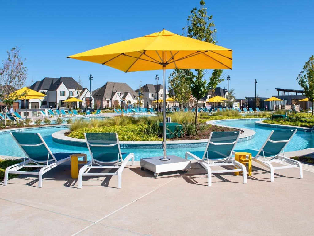 Bright yellow umbrella shading the Mosaic Amenity Center lazy river